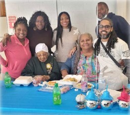 Lillian Boyd smiling with a group of people at her birthday party.