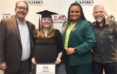 Shannon Alderman holding her degree.