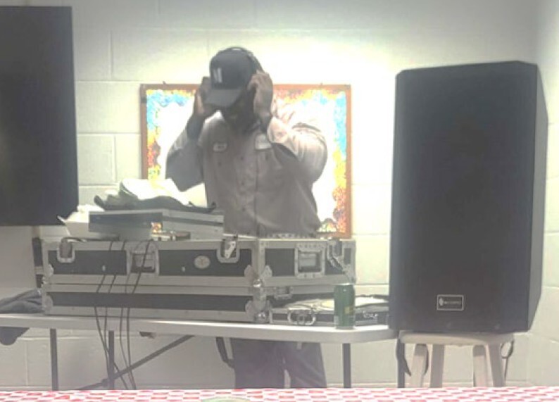 A DJ adjusting his headphones.