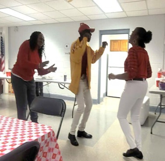 two women and a guy dancing.