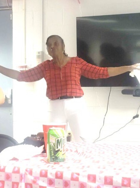 A woman standing with her arms out.