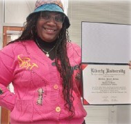 Martina Nelson holding her degree.