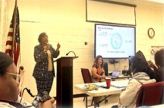 A woman speaking at the podium.