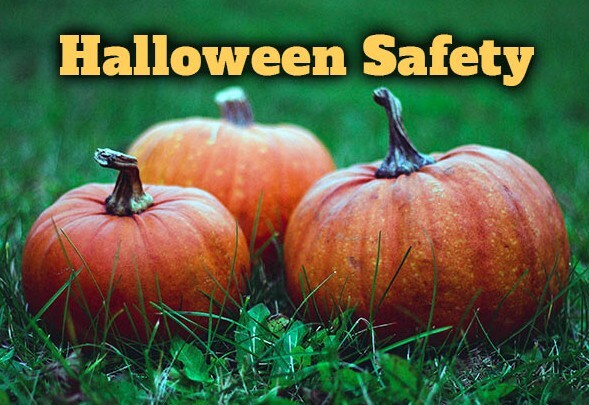 Halloween Safety. Three pumpkins sitting in the grass.