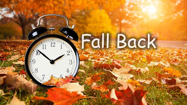Fall back. An alarm clock in the fall leaves.