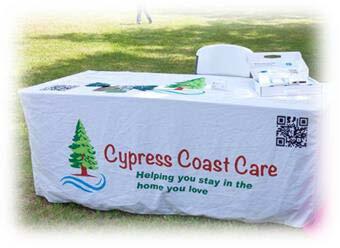 A table with a Cypress Coast Care table cloth. 
