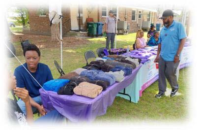 A man looking at items on a table.