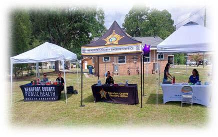 Three tables set up next to each other at the Elder Abuse Awareness event.