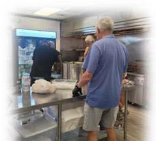 Three men working in a kitchen.