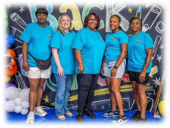 Five Back to School Bash workers standing side by side smiling.