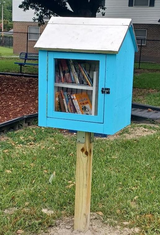 The little library sits outside, next to the playground and is already full of books to take.
