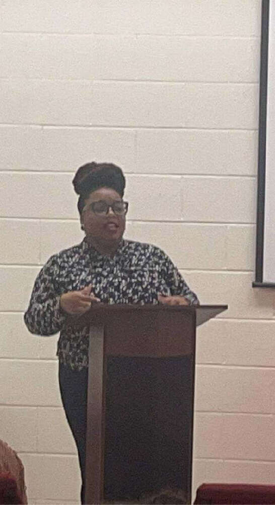 A woman speaking to a crowd.