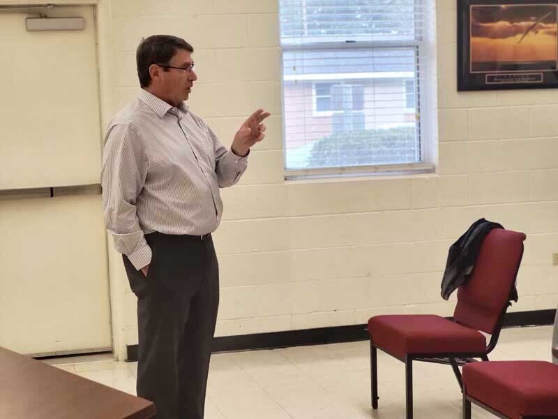 A man talking to a group.