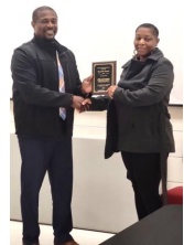 Shanette Roach shaking hands with Michael Best.