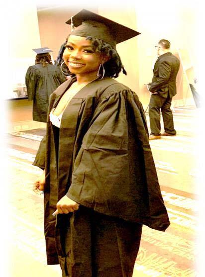 A woman in a cap and graduate gown.