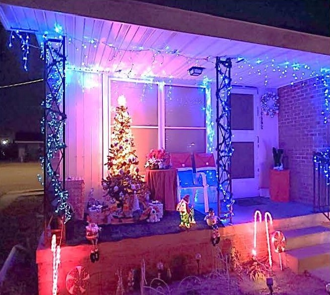The winning holiday decorations on the porch at night. 