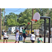 Four players watching another player trying to get a layup shot