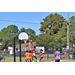Kid in pink jersey getting a layup shot