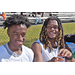 Two young men in white jerseys smiling for the camera