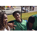 A young man in a green jersey smiling for the camera