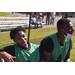 Two young men in green jerseys smiling