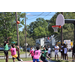 Guy in green jersey shoots a 3 pointer while other players prepare to get the ball