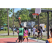 Two guys in pink jerseys try to block green jersey's shot