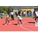 Orange jersey has the ball while white jersey guards him