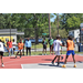 Spectators and players watch the young man with the ball