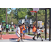 Player in white jersey goes around another player to get to the basket