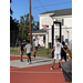 Kid in a white t-shirt jumping to make his shot