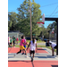 3 players in white watch while a player in pink is about to make a shot