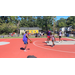 A player in purple bouncing the ball towards the basket