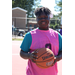 Player in a pink jersey and blue shirt holding the ball