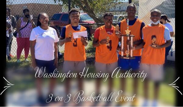 The ED standing beside four young men smiling and holding trophies.