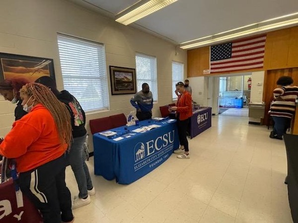 Teacher speaking with a representative from Elizabeth City State University