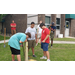 Young boys putting a steak in the ground