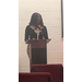 A woman speaks from the podium. 