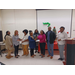 WHA staff presenting awards to two women at the front of the room. 