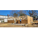 Two construction workers working on the framing of a house.