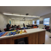 A closeup of a desk with students in the background.