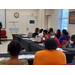 A group of students listening to a speaker.