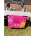 Two people sit behind a table with an Easter sign.