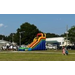 A view of children walking towards a large inflatable slide.
