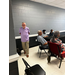 A man stands at the back of a meeting room.