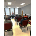 A speaker talks at the front of a classroom.