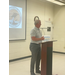 A man stands behind a podium.