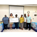 A group of people holding an oversized check.