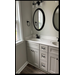 Bathroom view with two sinks and two mirrors with cabinets under sink.