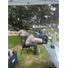 Some men sitting down in a grassy area.